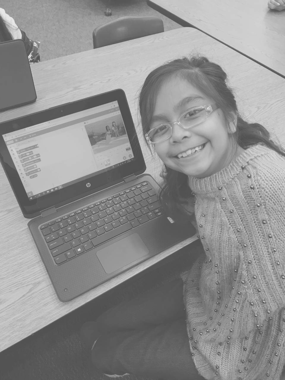 Girl smiling showing what she coded in Code.org